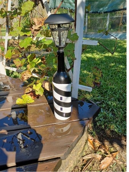 Wine bottle lighthouse on the deck